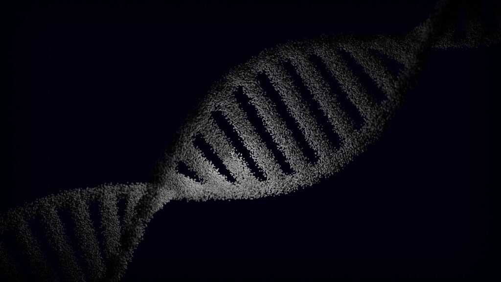 Representación artística de una cadena de ADN con efectos de partículas sobre un fondo oscuro.